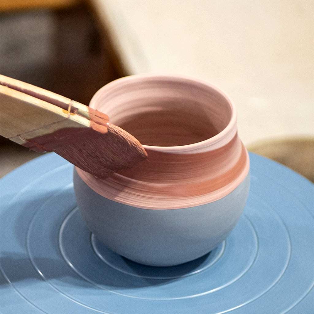 Ceramic gourd being hand glazed for yerba mate