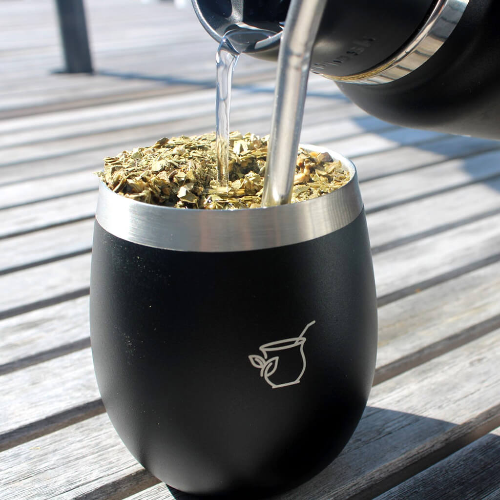 Pouring water into Rosamonte yerba mate from thermos
