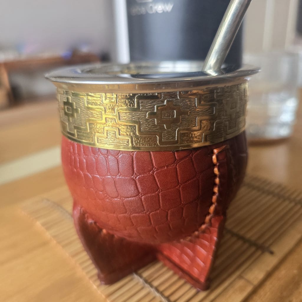 Salinas Grande leather gourd with stainless steel interior on a coffee table