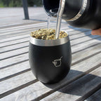 Pouring yerba mate into a stainless steel gourd