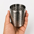 Hand holding the Ballena cold brew infuser, showing its size and hexagonal pattern.