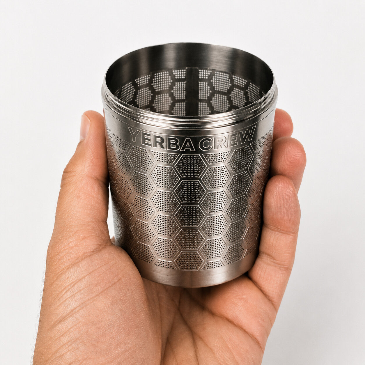 Hand holding the Ballena cold brew infuser, showing its size and hexagonal pattern.