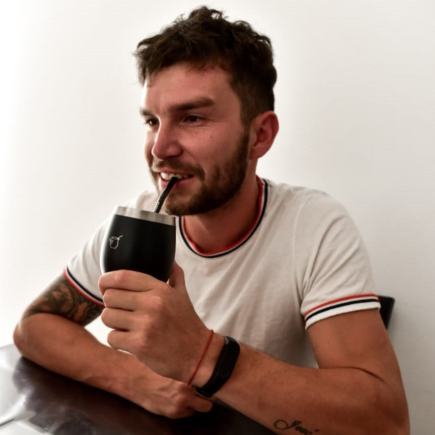 Drinking from a condor black mate with black bombilla