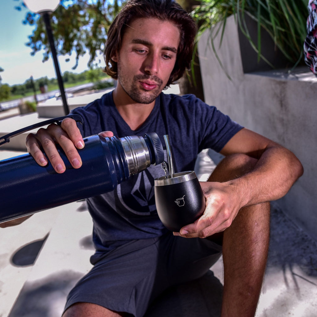 Yerba Crew pour water into mate with bombilla in Argentina