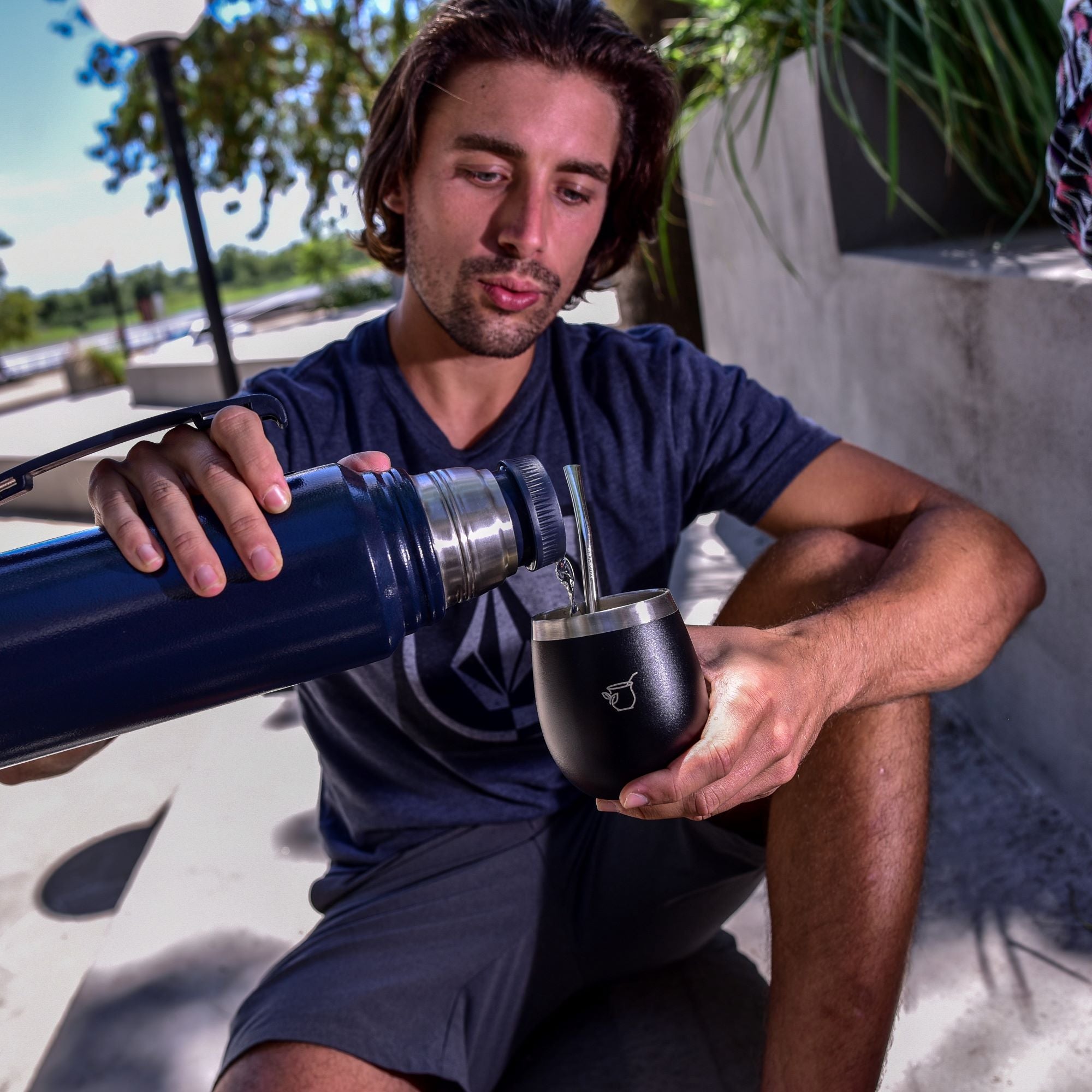 Yerba Crew pour water into mate with bombilla in Argentina